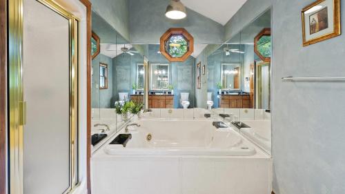 a large bathroom with a large tub and a sink at Marina Village by AvantStay Walk to Lake Marina Balcony Patio in Greentown