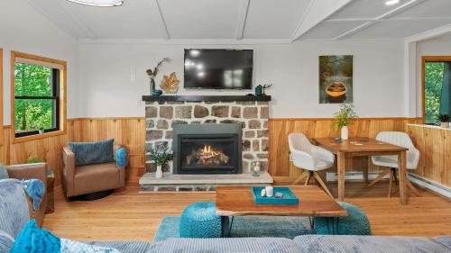 a living room with a fireplace and a tv at Summit Shores Tranquil Escape Designed for Groups w Fire Pit Game Room in Lake Harmony