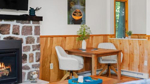 a living room with a table and a fireplace at Summit Shores Tranquil Escape Designed for Groups w Fire Pit Game Room in Lake Harmony