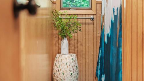 a vase with a plant in it on a wall at Summit Shores Tranquil Escape Designed for Groups w Fire Pit Game Room in Lake Harmony
