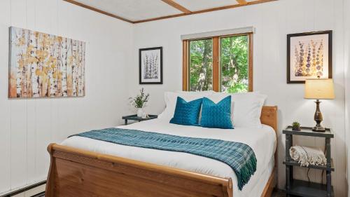 a bedroom with a large bed with blue pillows at Summit Shores Tranquil Escape Designed for Groups w Fire Pit Game Room in Lake Harmony