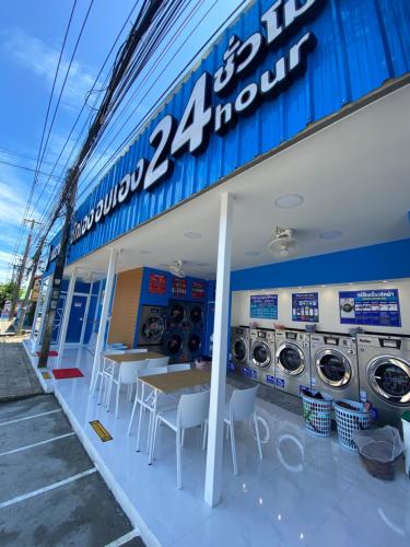 a gas station with a table and washing machines at Baan Laem Noi Villa's in Mae Nam