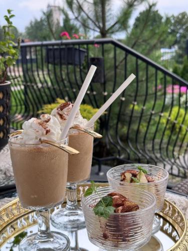 two glasses of ice creaminis sitting on a table at La Rose Residence in Mikołajki
