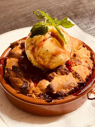 a plate of food on a table with a pie at Hostellerie Au rendez-vous des amis in Chaumont