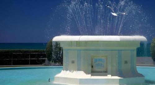 a building with a fountain in the middle of water at Stables Lodge Backpackers in Napier