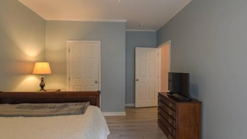 a bedroom with a bed and a tv on a dresser at Riverside Ranch by AvantStay Mins to Downtown in Arden