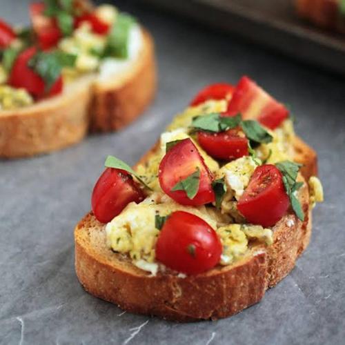 a piece of bread with eggs and tomatoes on it at Elegant homes , KENYA in Nairobi