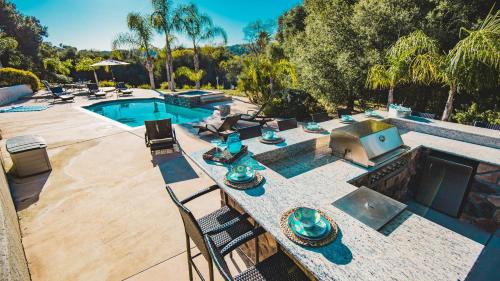 an overhead view of a pool with a table and chairs at Grapevine by AvantStay Secluded 5BR Villa 4 Acres of Vineyards Avo Groves in Temecula