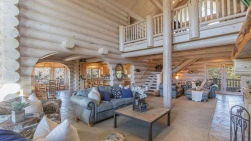 a living room with couches and a staircase at Hot Tub Game Room Large Deck w Incredible View Penticton Lodge by AvantStay in Big Bear Lake