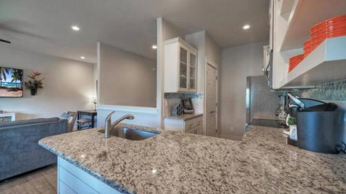 a kitchen with a sink and a counter top at Pool Walk to Old Town Eateries Nightlife Shopping Rock N Reelby AvantStay in Port Aransas