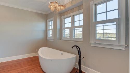 a white bath tub in a room with windows at 20 Morgan Place Drive by AvantStay Waterfront Home w Private Dock in Isle of Palms