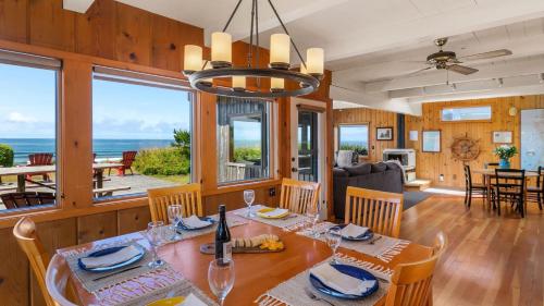 a dining room and living room with a table and chairs at The Pilot House by AvantStay Stunning Home Right On Arch Cape Beach in Arch Cape