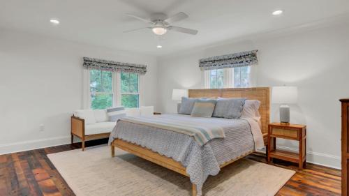 a bedroom with a bed and a ceiling fan at Be a Sullivans Local 1307 Cove Avenue by AvantStay Pool Outdoor Living in Sullivans Island