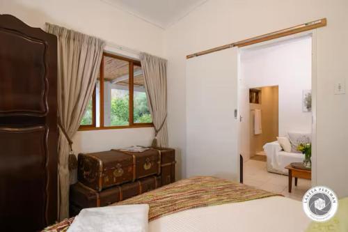 En eller flere senge i et værelse på Wijnberg cottage