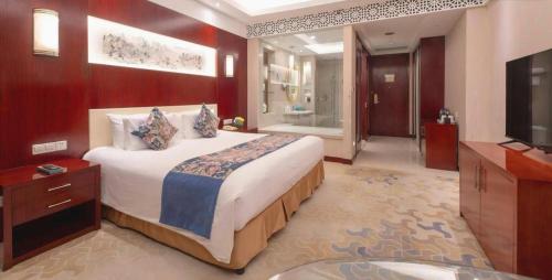 Katil atau katil-katil dalam bilik di New Century Hotel Zaozhuang Fengming