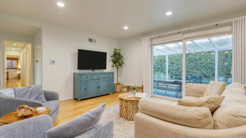 a living room with couches and a flat screen tv at Goleta Getaway by AvantStay Private Backyard 1.5mi to the Beach in Santa Barbara