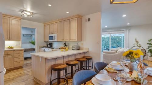a kitchen and living room with a table and chairs at Goleta Getaway by AvantStay Private Backyard 1.5mi to the Beach in Santa Barbara