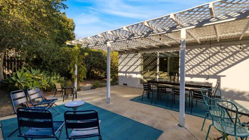 a patio with chairs and a table under a pergola at Goleta Getaway by AvantStay Private Backyard 1.5mi to the Beach in Santa Barbara