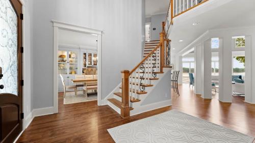 a staircase in a home with white walls and a dining room at Paradise Pointe by AvantStay Lakefront Views Playset in Lake Norman of Catawba