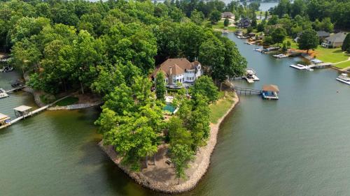 an aerial view of a house on an island in a river at Paradise Pointe by AvantStay Lakefront Views Playset in Lake Norman of Catawba