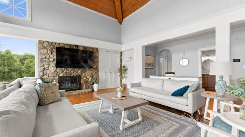 a living room with a couch and a fireplace at Paradise Pointe by AvantStay Lakefront Views Playset in Lake Norman of Catawba