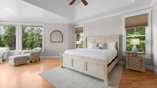a bedroom with a white bed and two windows at Paradise Pointe by AvantStay Lakefront Views Playset in Lake Norman of Catawba