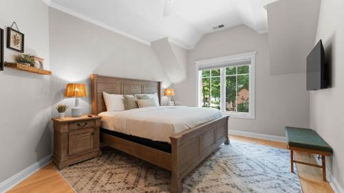 a bedroom with a large bed and a window at Paradise Pointe by AvantStay Lakefront Views Playset in Lake Norman of Catawba