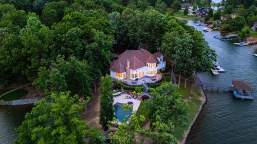 a large house on an island in the water at Paradise Pointe by AvantStay Lakefront Views Playset in Lake Norman of Catawba