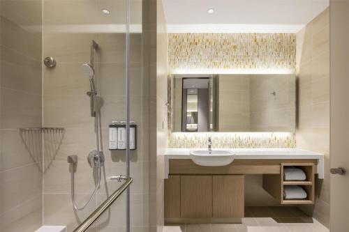 a bathroom with a sink and a shower at Hyatt Place New Taipei City Xinzhuang in Xinzhuang