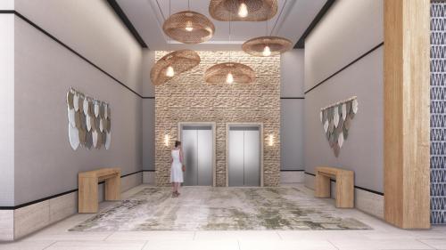 a woman in a white dress standing in a hallway at Hyatt Place Cancun Airport in Cancún