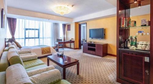 a hotel room with a couch and a bed at Datong Tiangui International Hotel in Datong