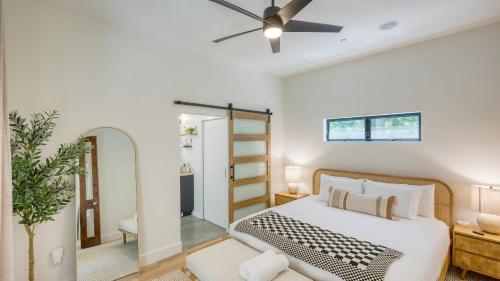 a bedroom with a bed and a ceiling fan at Mill Creek by AvantStay Modern Design Patio Hot Tub in Healdsburg