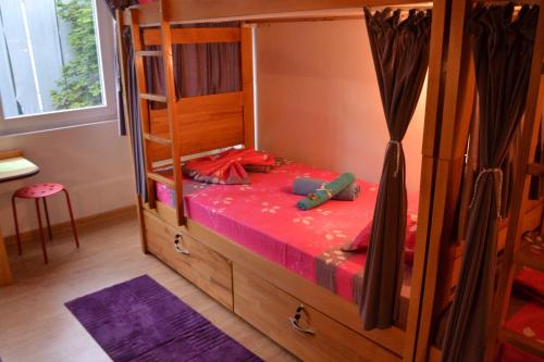 a bedroom with a bunk bed with a wooden cabinet at Skopje Hostel in Skopje