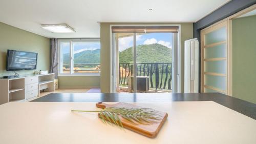 a kitchen with a table with a view of a mountain at Gapyeong Applerotgi Pension in Gapyeong