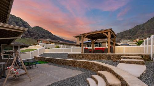 a patio with a gazebo with mountains in the background at Makaha Villa by AvantStay Mountain Ocean Views in Waianae