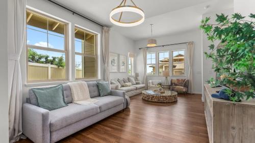 a living room with a couch and a table at Makaha Villa by AvantStay Mountain Ocean Views in Waianae