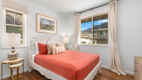 a bedroom with a bed and a window at Makaha Villa by AvantStay Mountain Ocean Views in Waianae