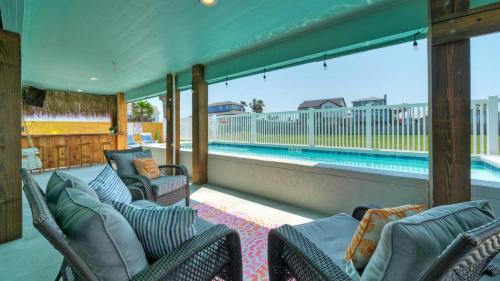 a porch with chairs and a swimming pool at Private Pool Free Golf Cart 3 Blocks to Town Tequila Tides by AvantStay in Port Aransas