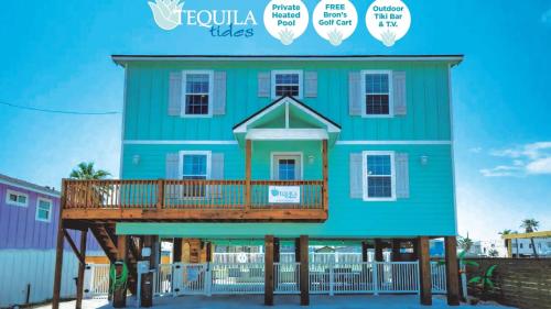 a blue house with a porch and a deck at Private Pool Free Golf Cart 3 Blocks to Town Tequila Tides by AvantStay in Port Aransas