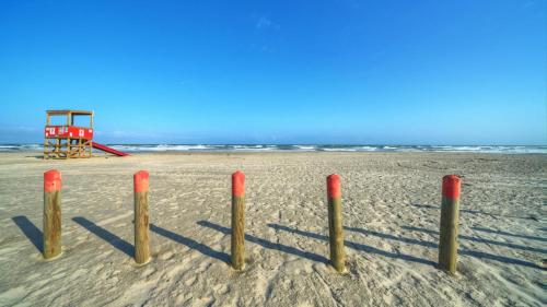 a beach with a life guard station in the sand at Private Pool Free Golf Cart 3 Blocks to Town Tequila Tides by AvantStay in Port Aransas