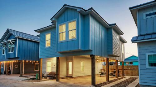 a house with a blue roof at Free Heated Pool Golf Cart Zone Sea La Vie by AvantStay in Port Aransas