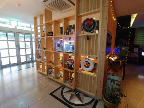 a wooden shelf in a room with christmas decorations at SKY Hotel in Changwon