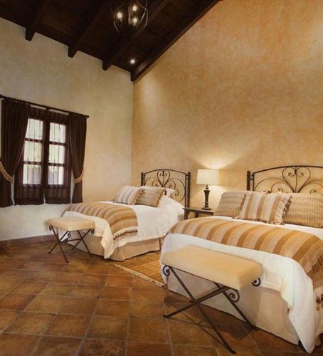 a large bedroom with two beds and a window at Hotel Casa Suwon in Suwon