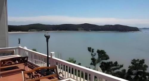 a balcony with a view of a body of water at Gallery Pension in Taean