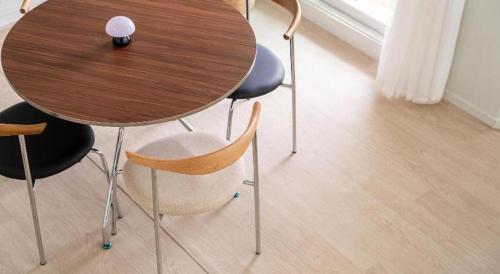a wooden table with two chairs and a wooden table at Gallery Pension in Taean