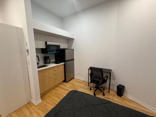 a small room with a kitchen and a chair in it at Well located studio with Parking near Downtown Montreal in Montréal