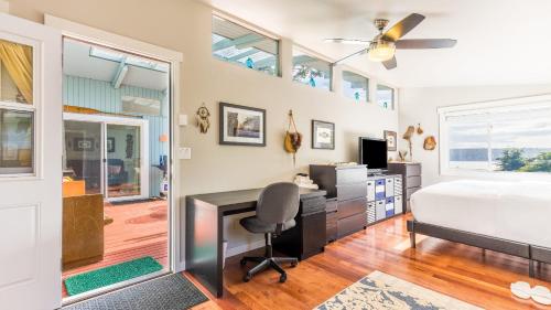 a bedroom with a bed and a desk with a computer at Wolf Beach Cottage by AvantStay Harbor Views in Langley
