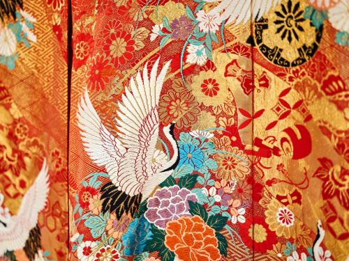 a close up of a blanket with flowers and birds at Tabist Chikuba Shinyotei Hakodate Yunokawaonsen in Hakodate