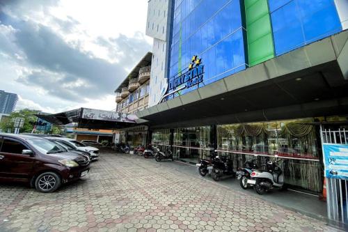 a group of motorcycles parked in front of a building at Lucky Star Hotel Near Harbour Bay Batam in Nagoya