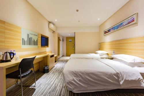a hotel room with two beds and a desk at City Comfort Inn Wuhan Hankou Railway Station West Square in Wuhan